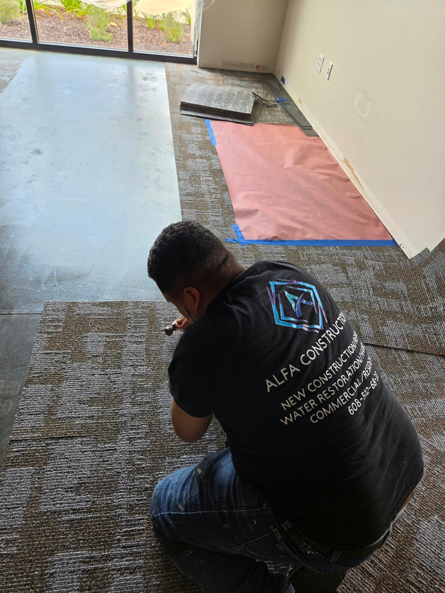ALFA Construction branded work shirt during flooring work